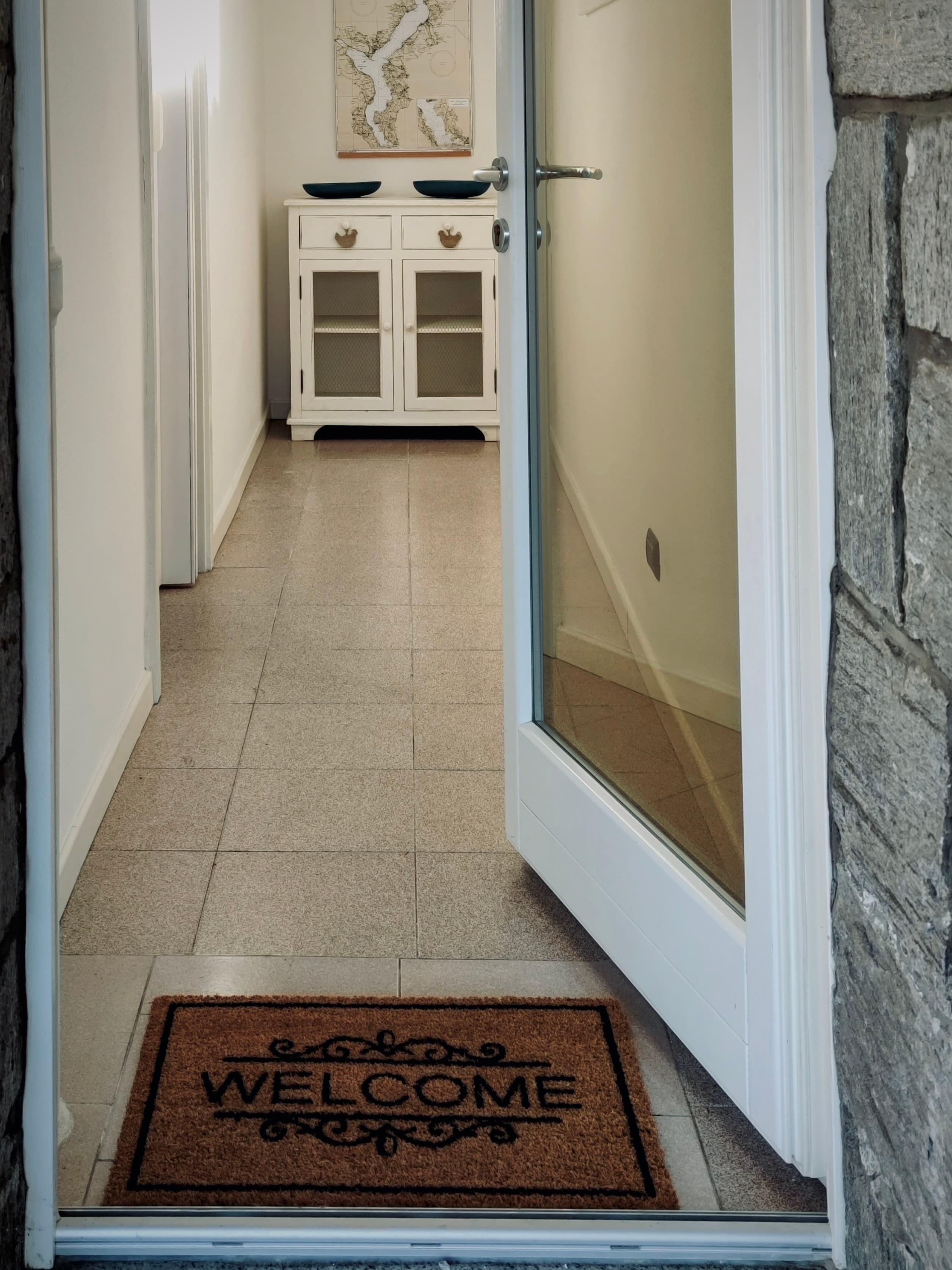 The entrance doorway with a welcome mat