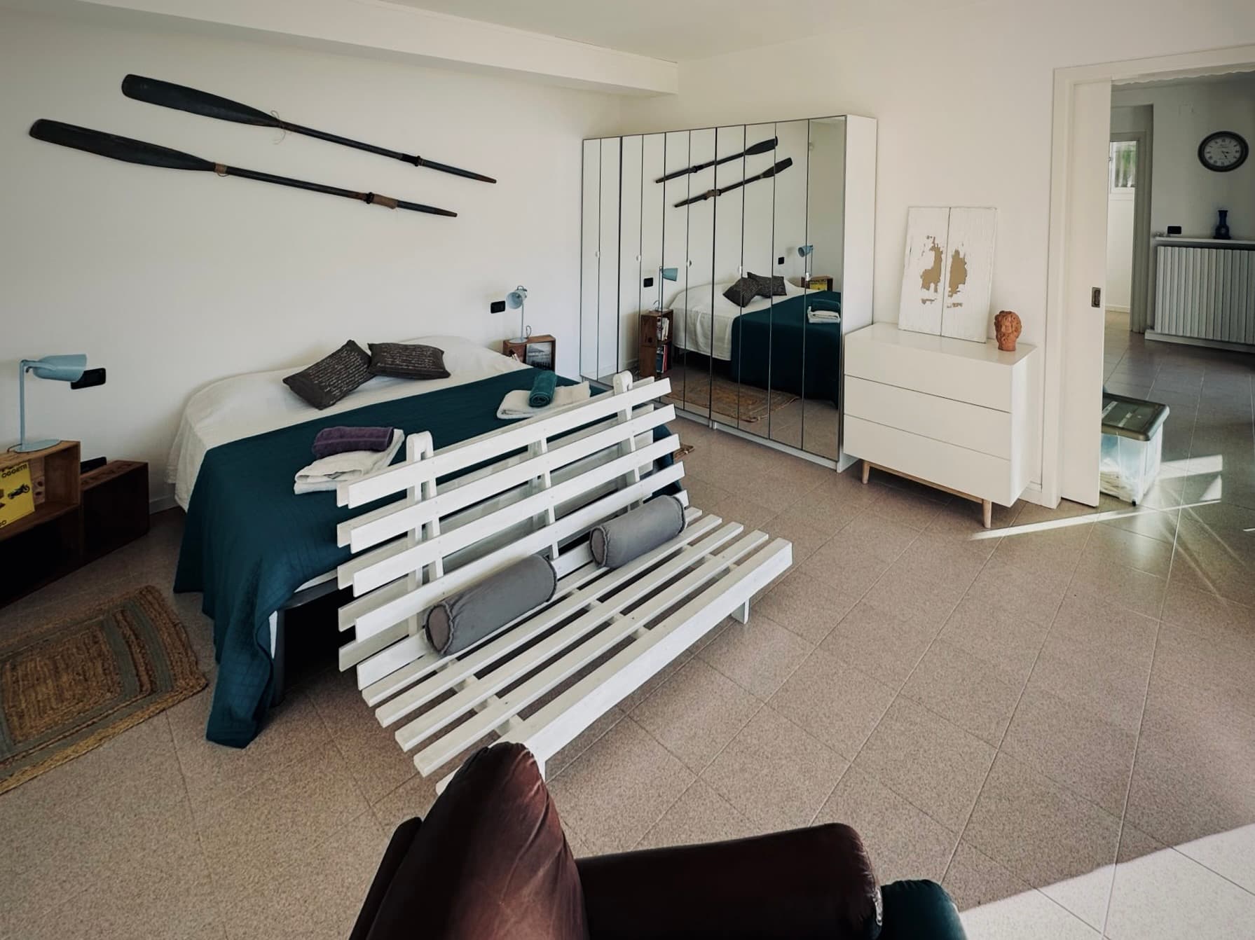 A wide view of the bedroom with the bed and storage