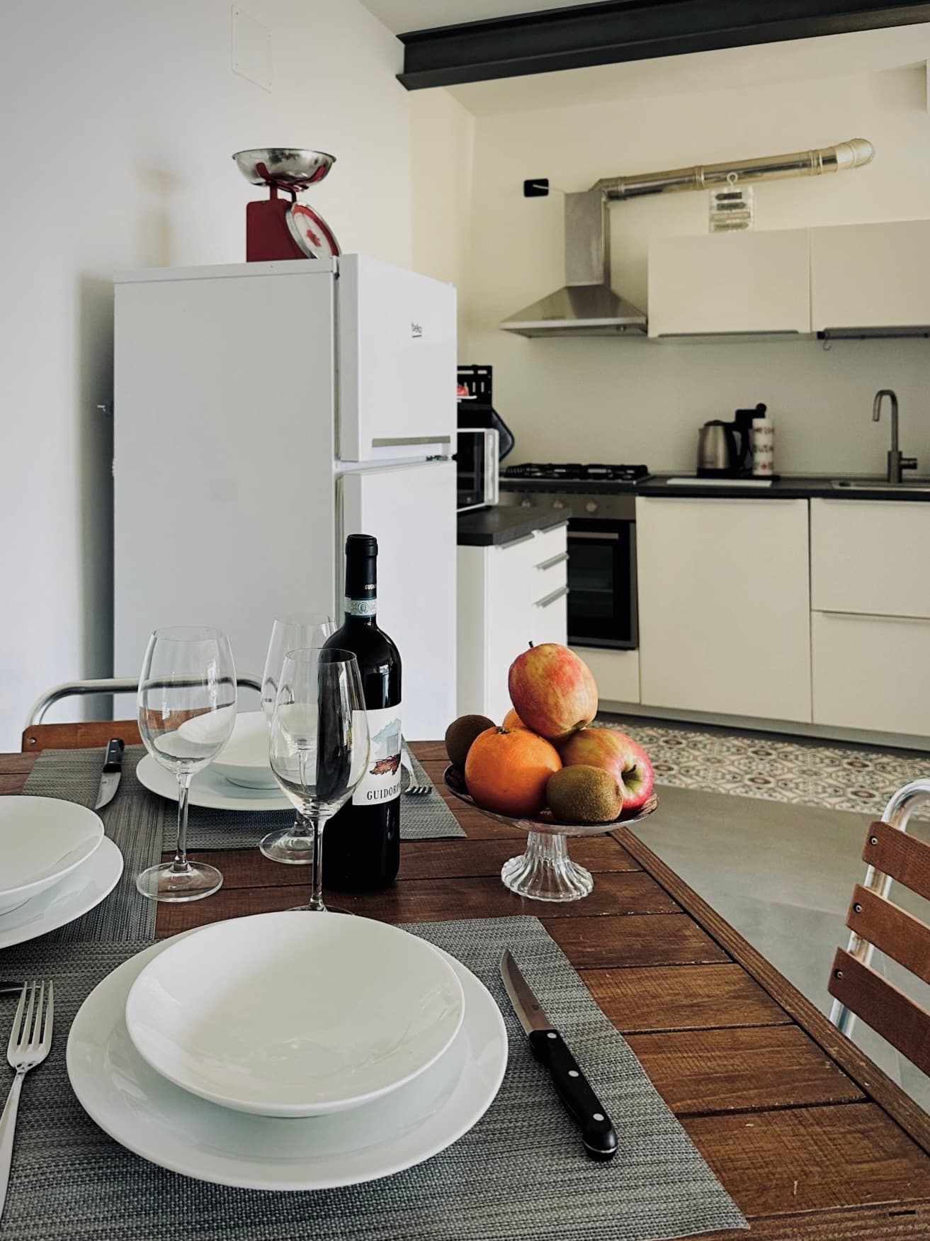 The kitchen beside a wooden dining table