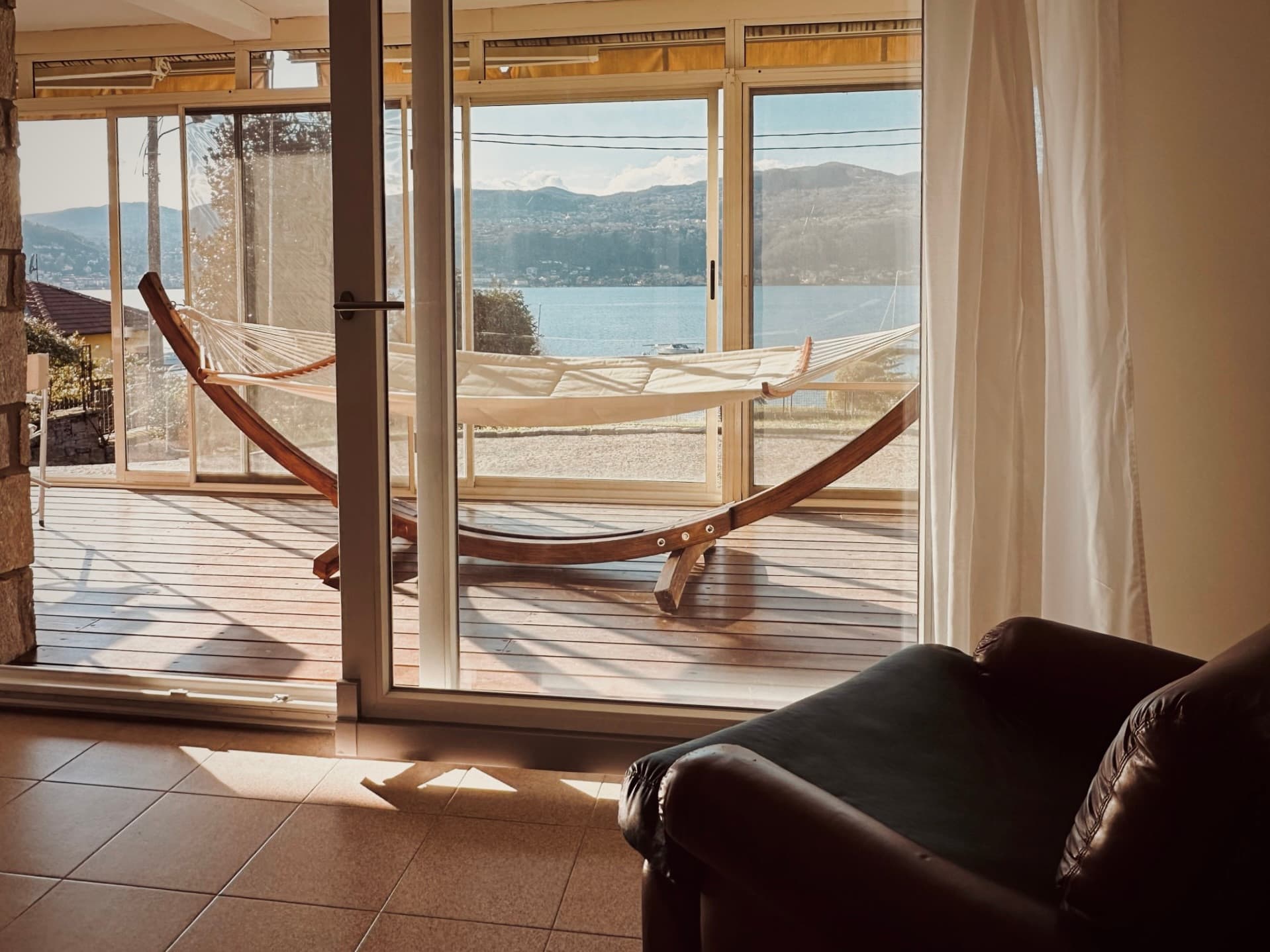 The living room opening onto the glazed veranda and hammock