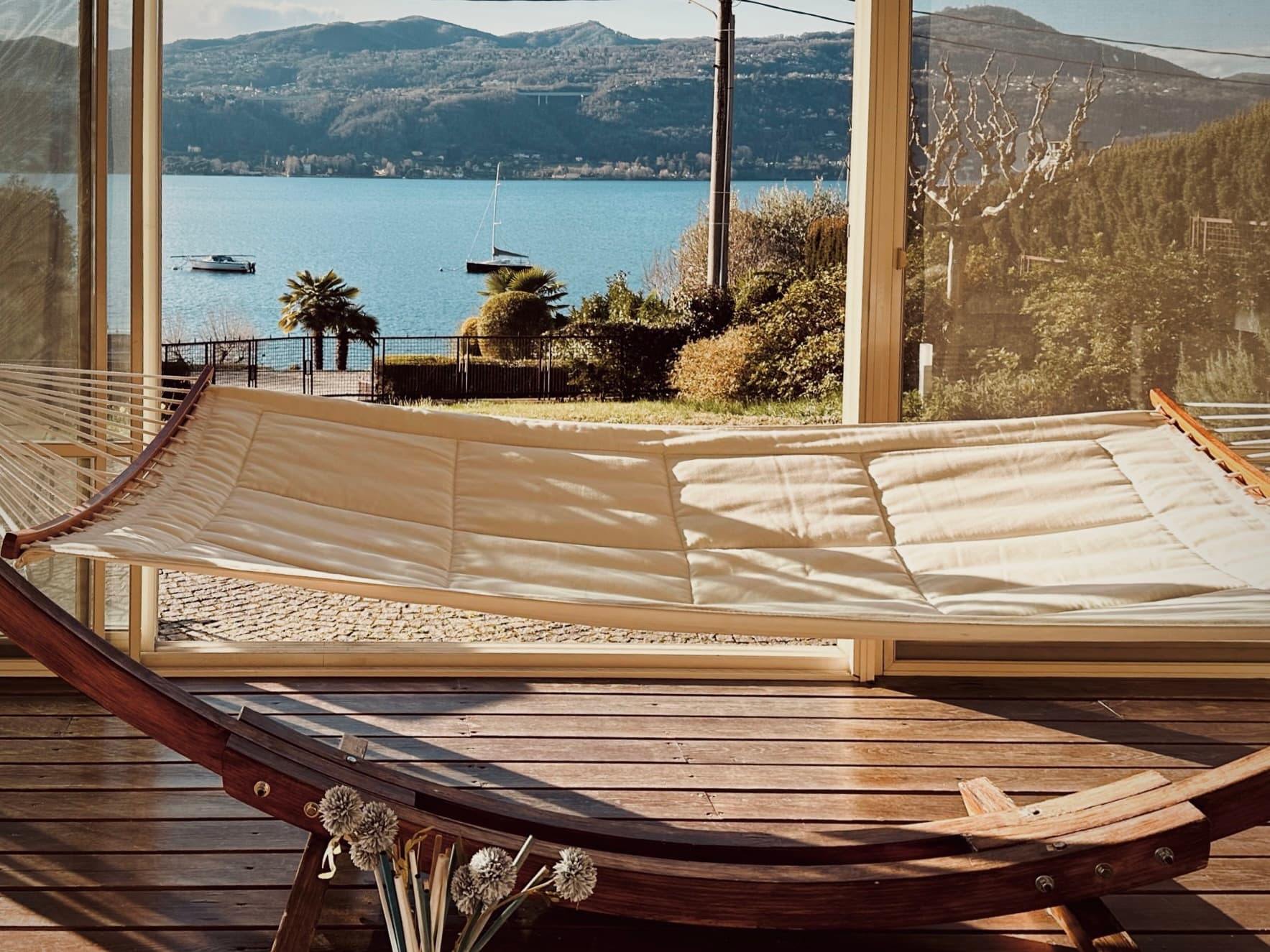 A hammock hanging on the veranda overlooking the lake