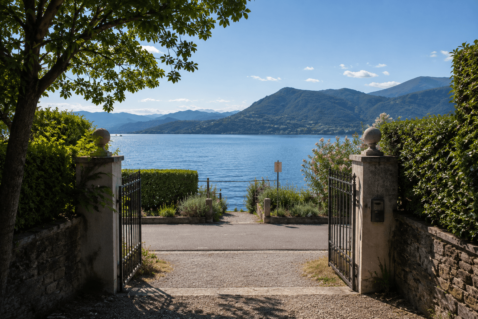Open garden gates leading toward Lake Maggiore